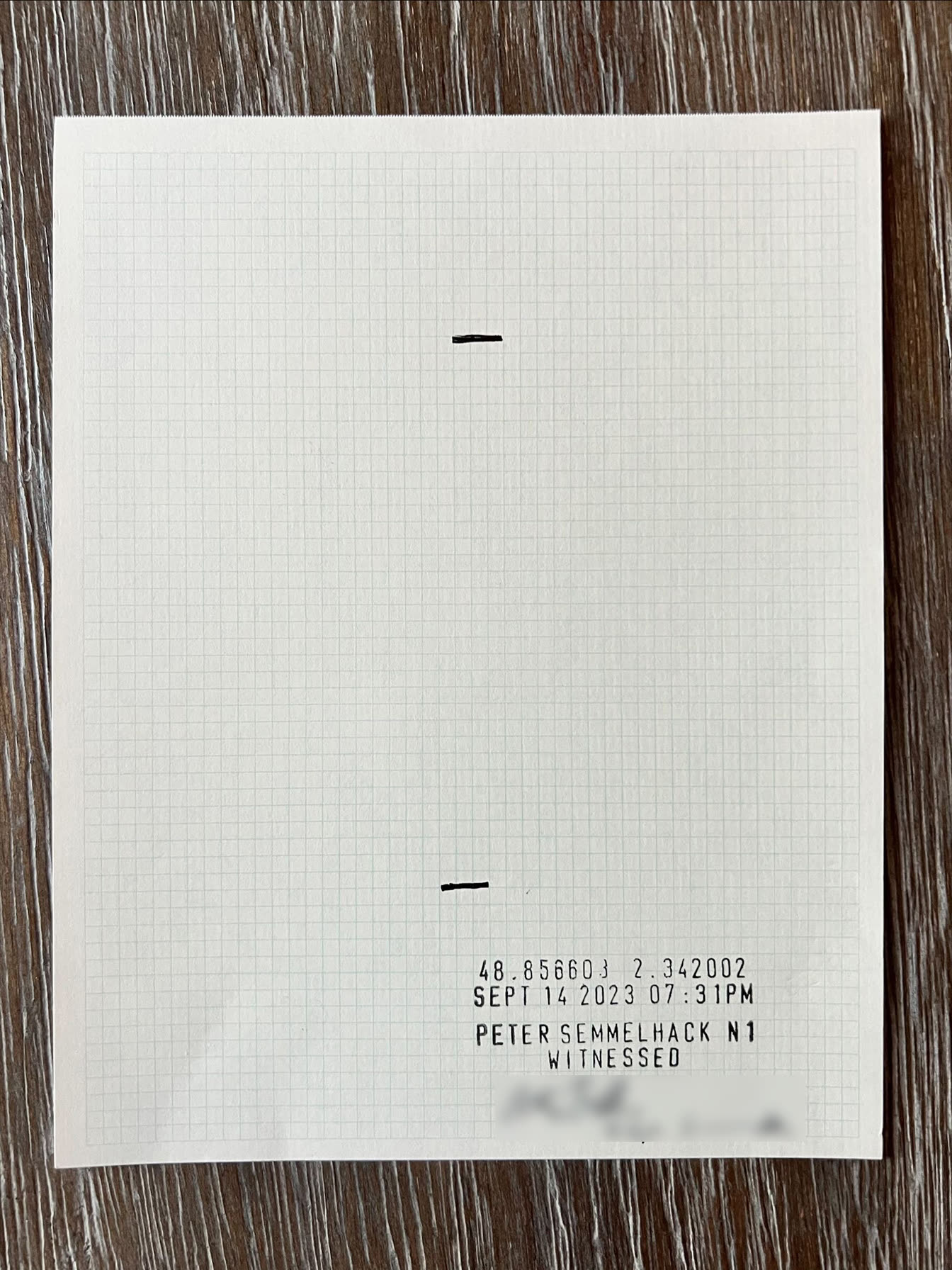 Grid paper with two short black marks and a stamp reading 48.856603 2.342002 and SEPT 14 2023 07:31PM. The signature is blurred.